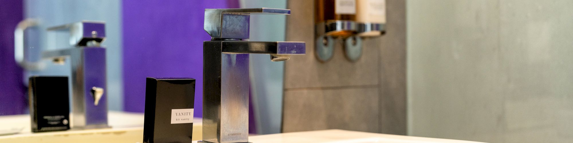 A modern bathroom sink with a sleek faucet and mirror