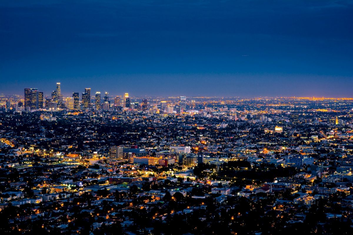 A nighttime cityscape with skyscrapers and lights